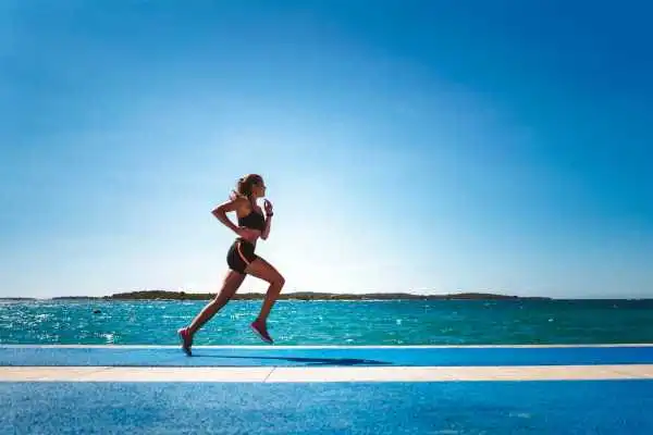Woman running showing strong leg muscle Livingston